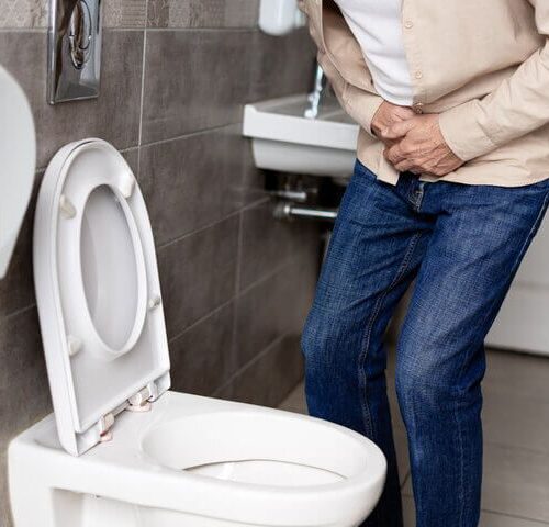 Anciano con problemas urinarios en el baño de su casa